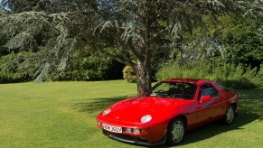 1980 Porsche 928 parked under a tree