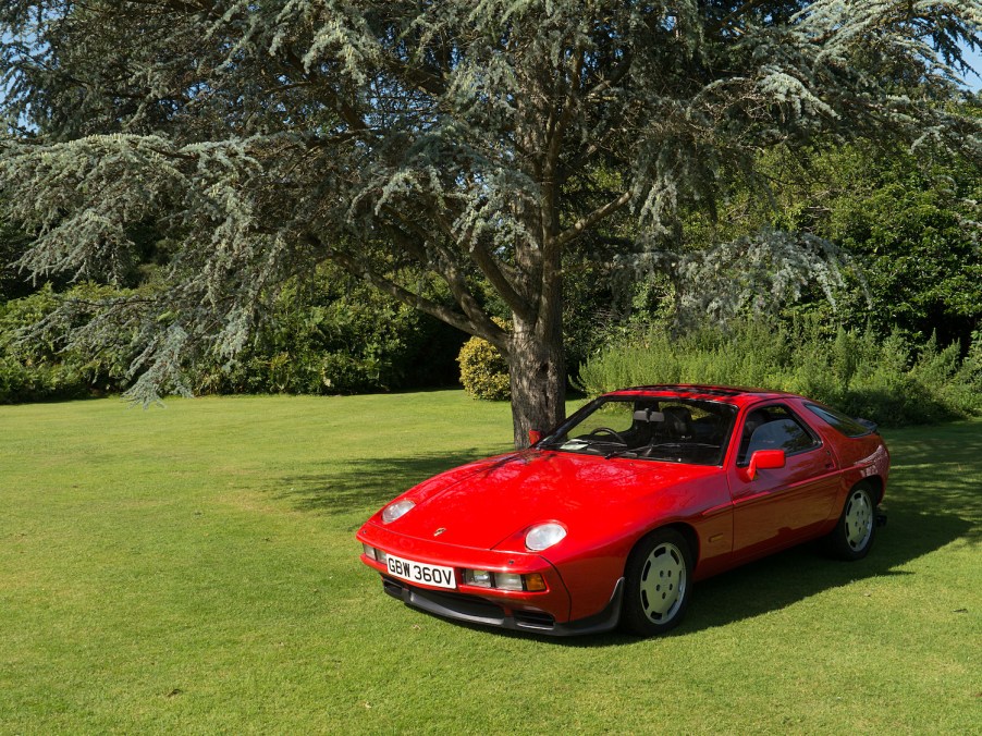 1980 Porsche 928 parked under a tree