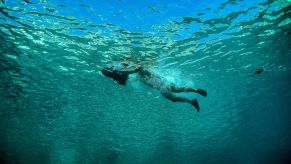 A tourist swimming with a sea scooter in Ithaca, Greece