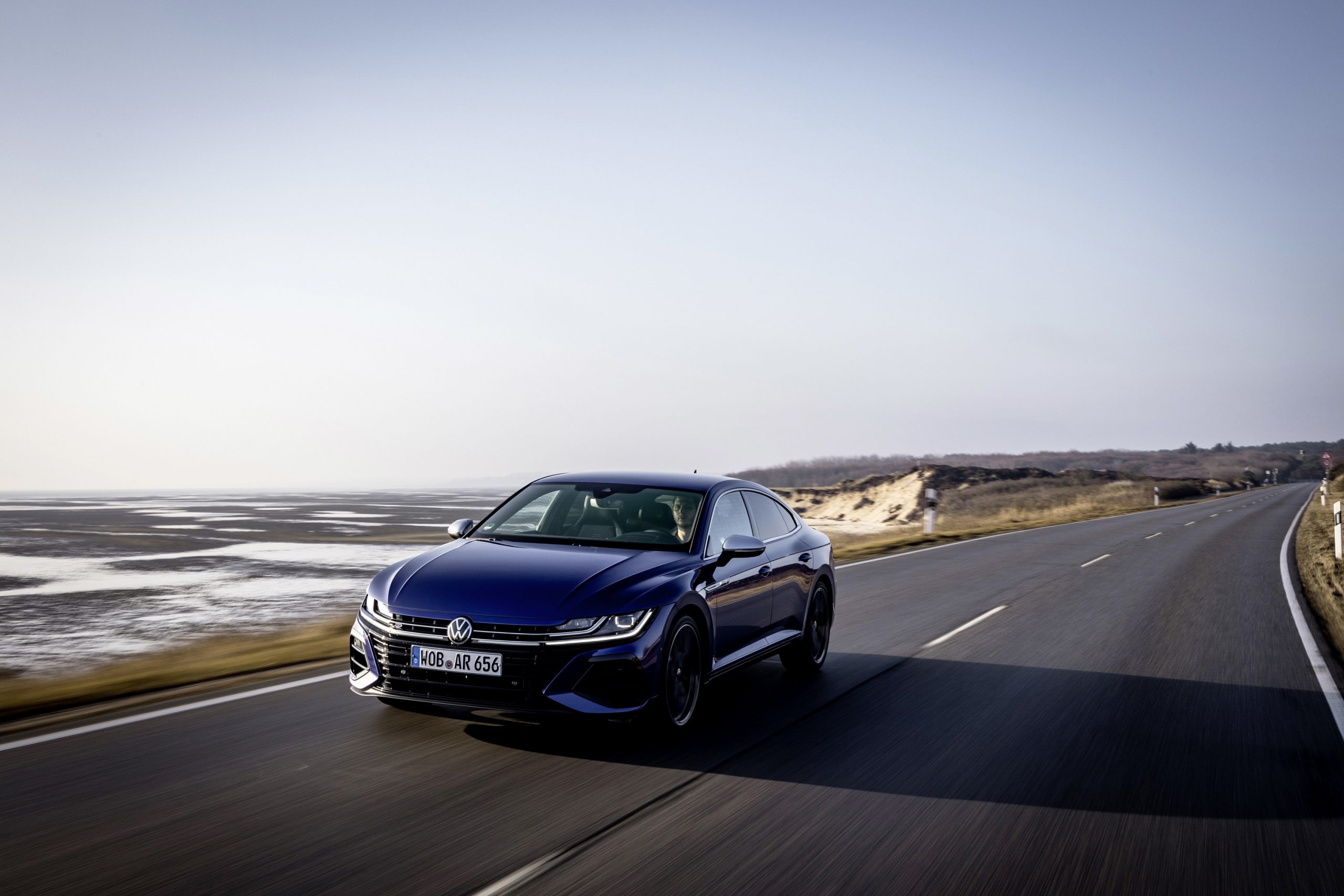 A blue Volkswagen Arteon R at the seaside