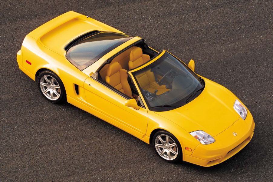 The overhead view of a yellow 2005 Acura NSX-T with its roof off