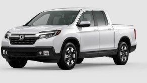 A white Honda Ridgeline against a white background.