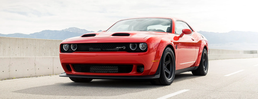 The 2021 Dodge Challenger SRT Super Stock muscle car with a Dual Snorkel Hood parked on a highway