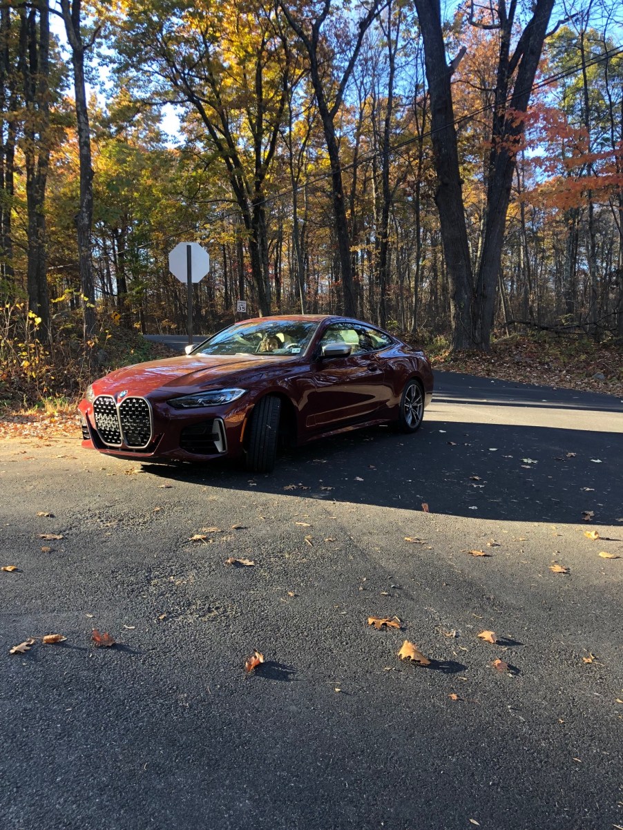 2022 BMW M440i review unit is metallic red parked on the road