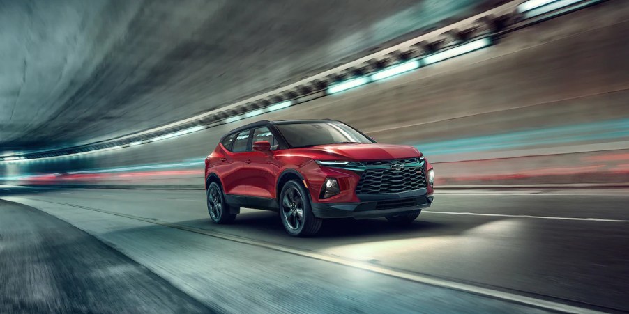 A red 2022 Chevy Blazer drives through a tunnel at night