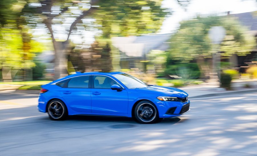 A blue 2022 Honda Civic shot in motion from profile