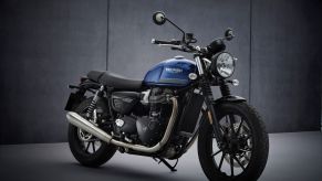 A blue-and-black 2022 Triumph Street Twin in a studio