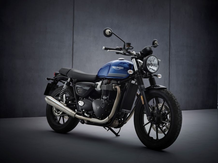 A blue-and-black 2022 Triumph Street Twin in a studio