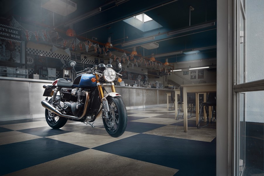 A blue-white-red-and-black 2022 Triumph Thruxton RS Ton Up Special Edition in a garage