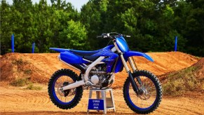 A blue-and-black 2022 Yamaha YZ250F 4-stroke dirt bike at a motocross track