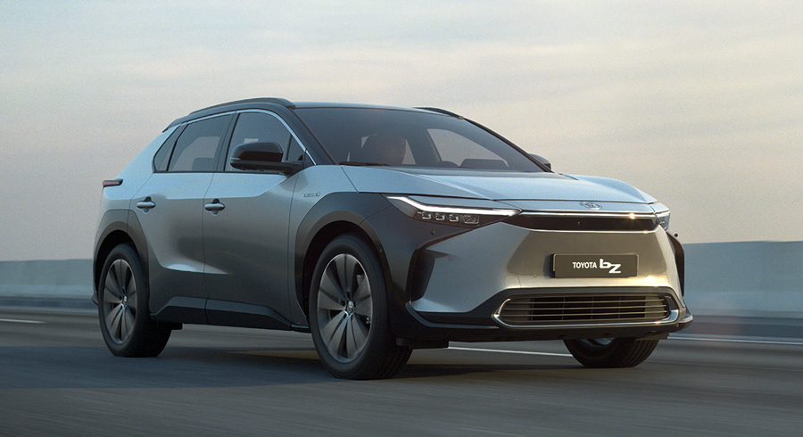 A silver 2022 Toyota bZ4x driving along the highway.