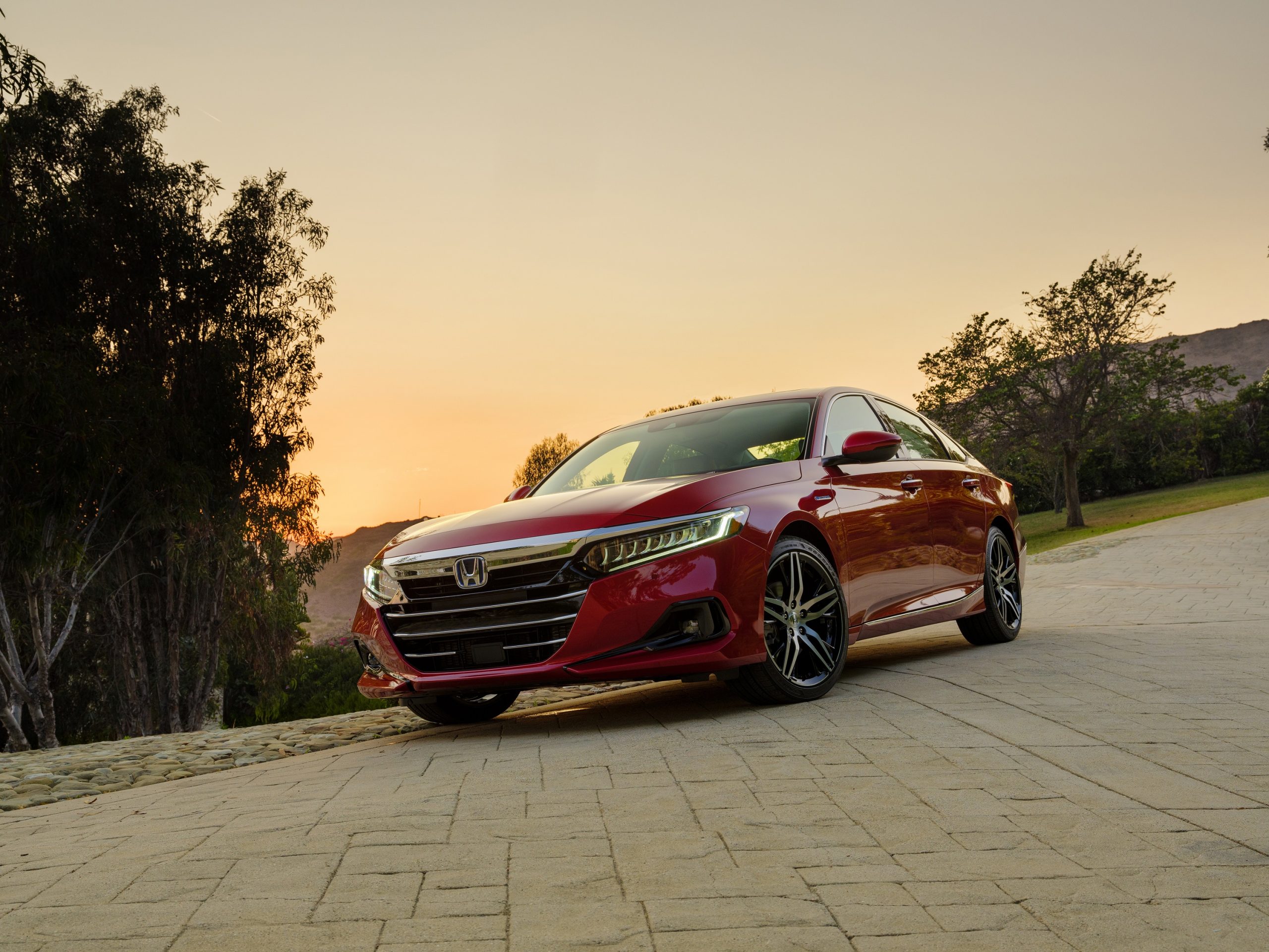 A red Accord shot from the front 3/4 at sunset