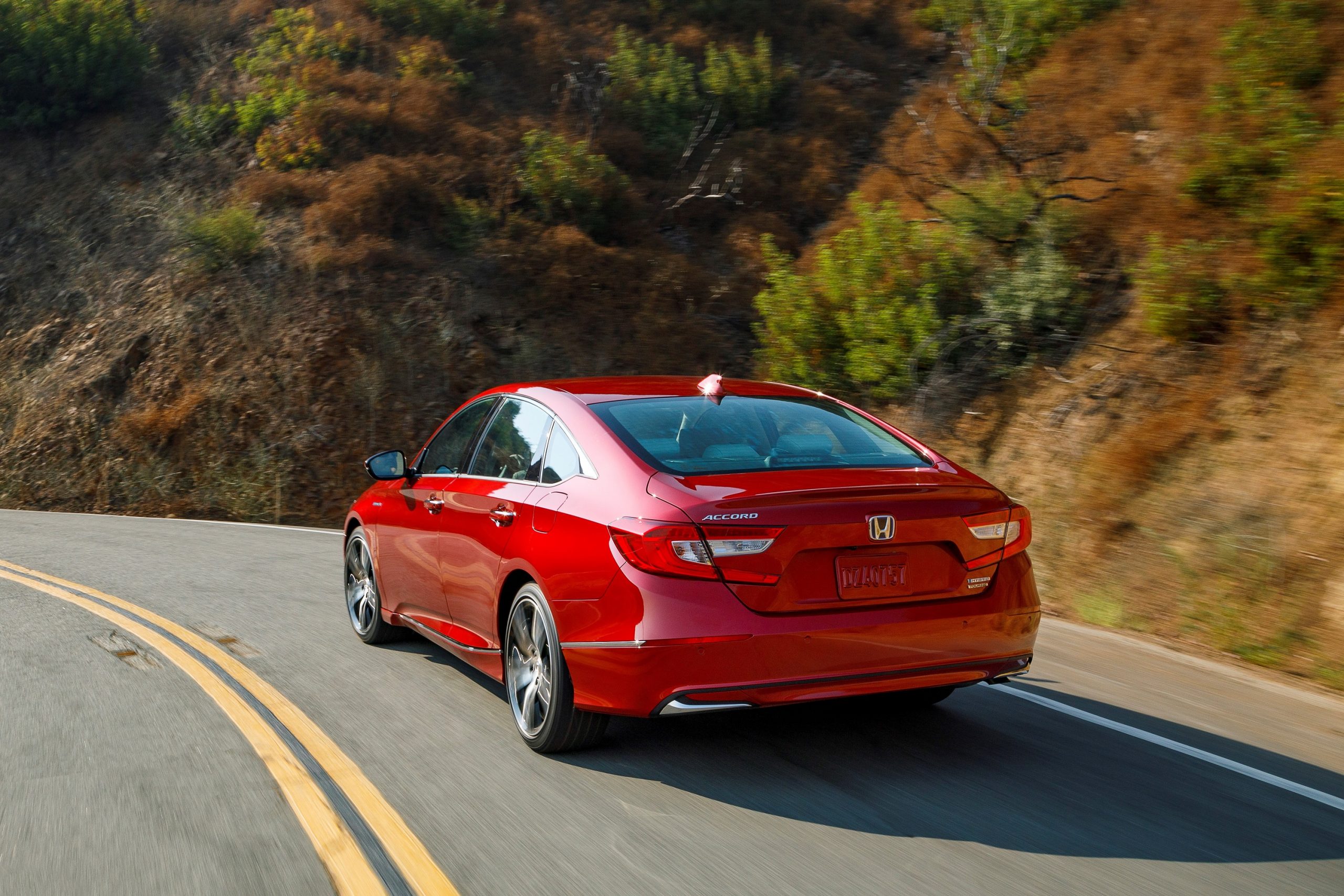 A rear 3/4 shot of the 2022 Accord in red.