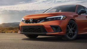 An orange VTEC-powered 2022 Honda Civic Si shot from the front