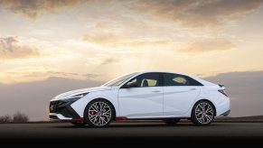 A white 2022 Hyundai Elantra N shot from the front 3/4 at sunset