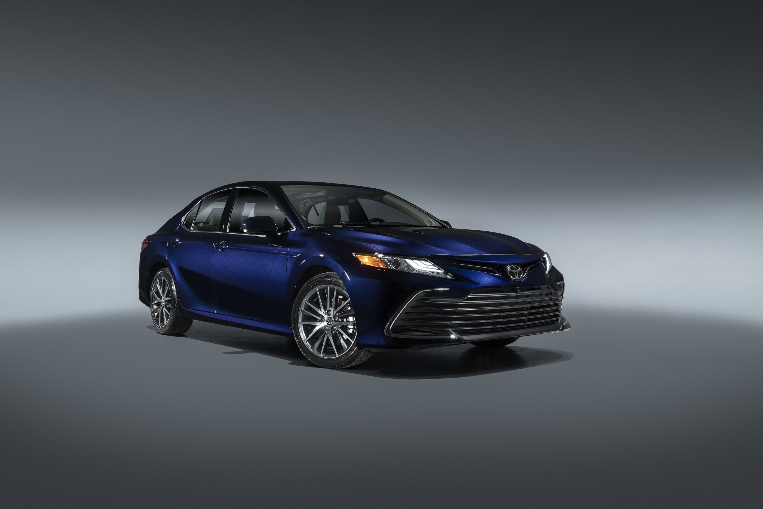 A dark blue 2022 Toyota Camry shot from the front 3/4