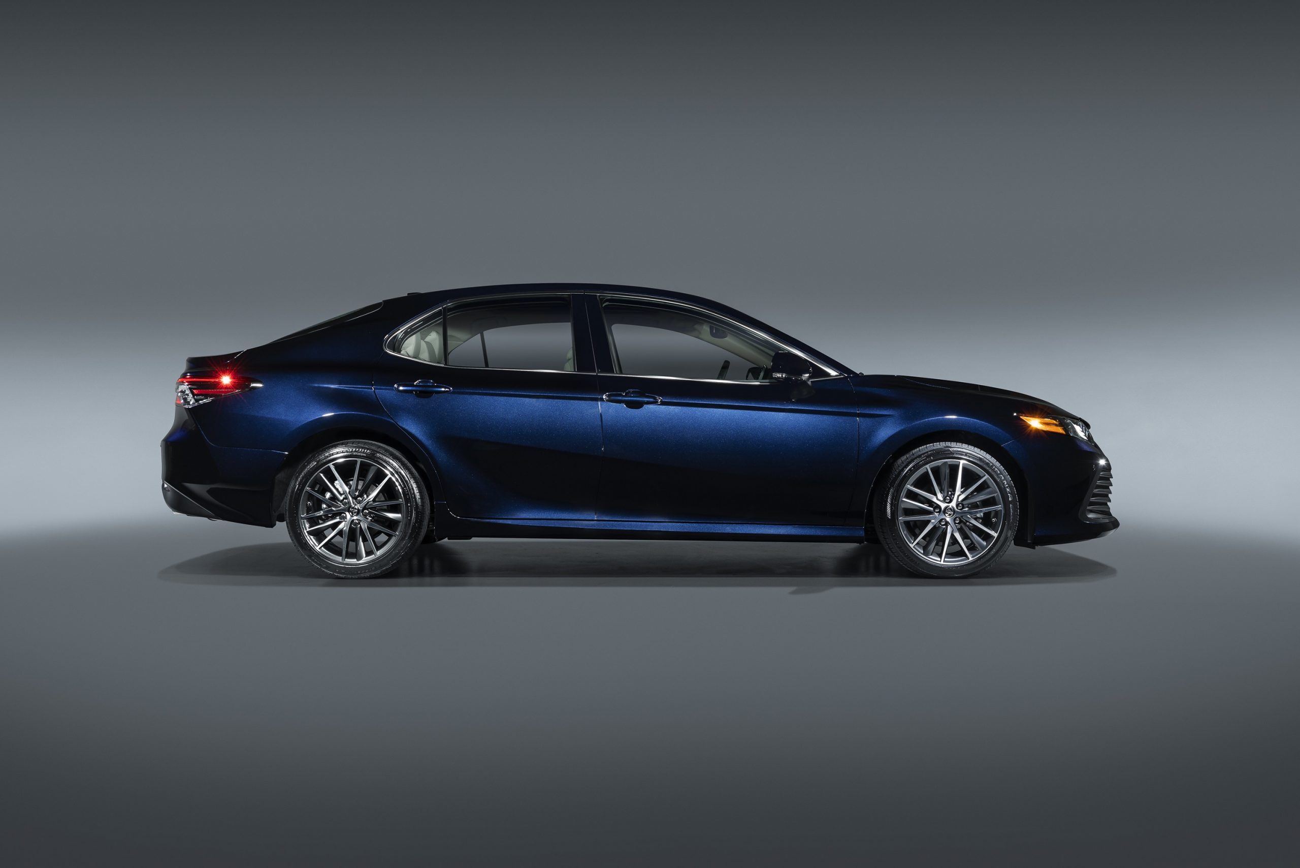 A dark blue 2022 Toyota Camry shot in profile