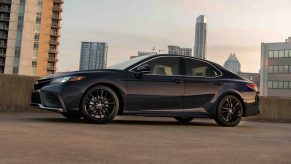 A profile shot of a black 2022 Toyota Camry sedan at sunset