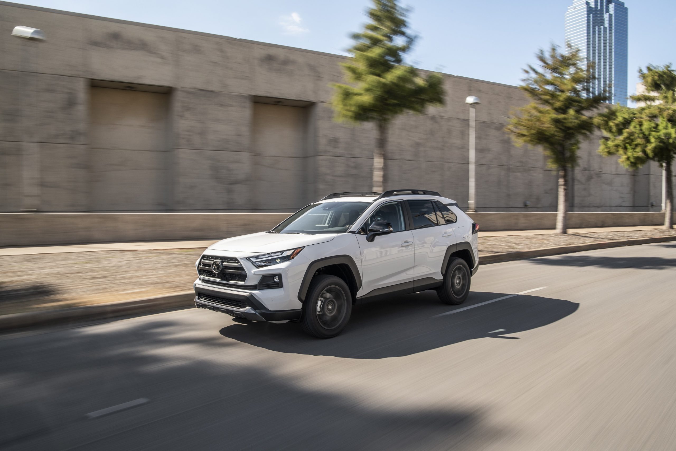 A white 2021 Toyota RAV4 SUV shot from the front 3/4 on a city street