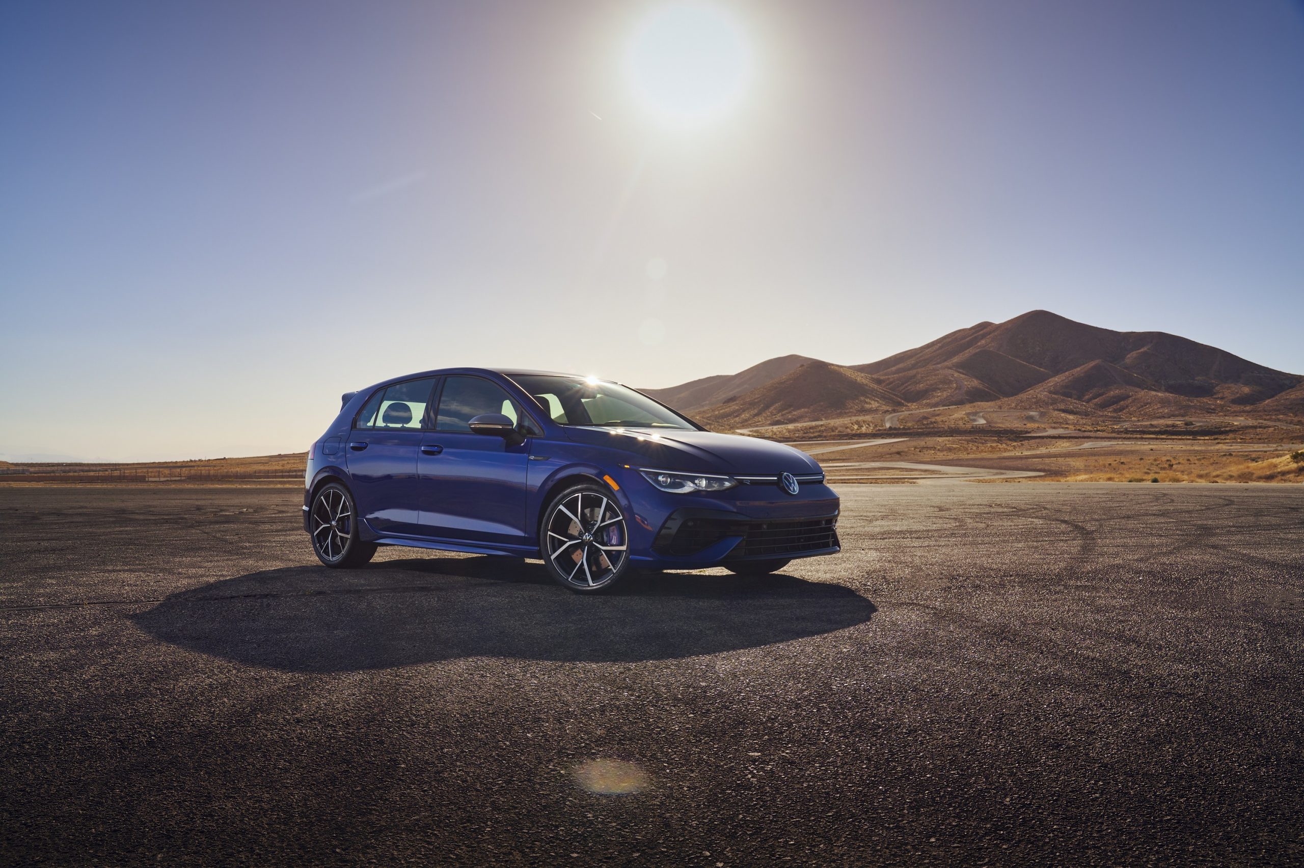 A blue 2022 Volkswagen Golf R shot from the 3/4 angle