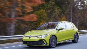 A yellow 2022 Volkswagen GTI shot from the front 3/4 on a country road