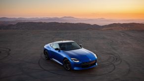 A blue 2023 Nissan Z shot from the high 3/4 angle at sunset