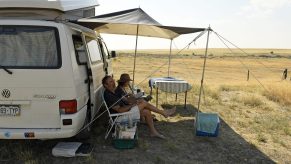 A couple relaxing at an RV campgroundA couple relaxing at an RV campground