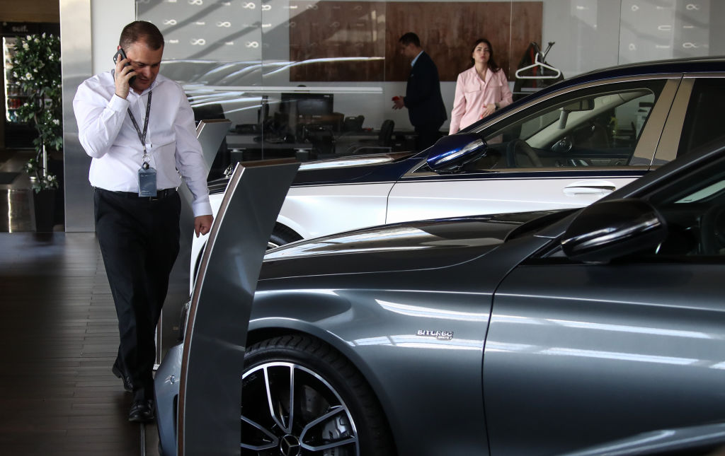 car salesman on the phone in dealership