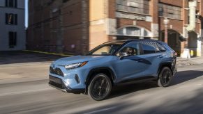 Cavalry Blue 2022 Toyota RAV4 driving down a street