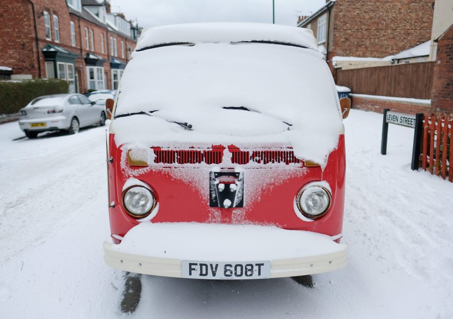 Classic camper van covered in snow