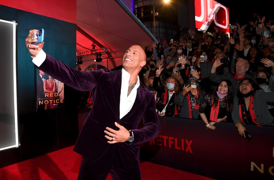 This is Dwayne The Rock Johnson, star of Red Notice, in which he drove a Porsche Taycan | | Kevin Mazur/Getty Images for Netflix