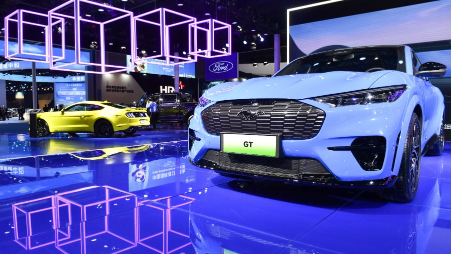 A blue Ford Mustang Mach-E is on display.