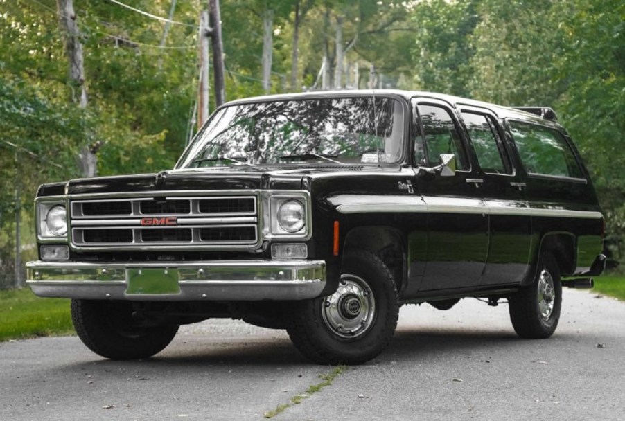 A black 1976 GMC Suburban Sierra.