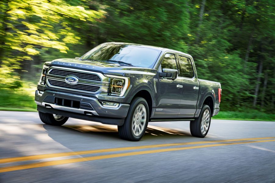 Gray 2022 Ford F-150 Limited driving by a forest