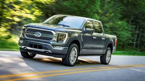 Gray 2022 Ford F-150 driving by a forest