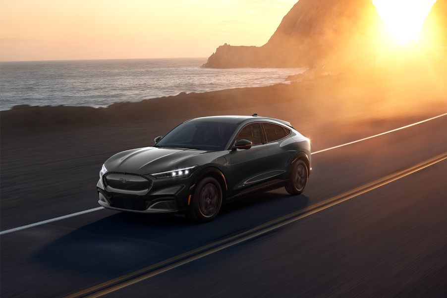 Gray 2022 Ford Mustang Mach-E electric crossover driving on a coastal road