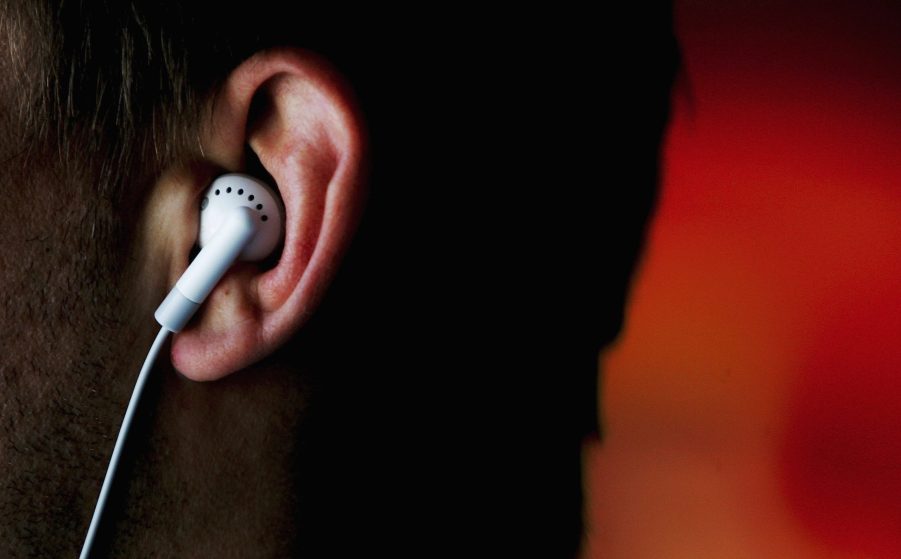 Headphones inside a person's ears, which is illegal while driving in some areas.