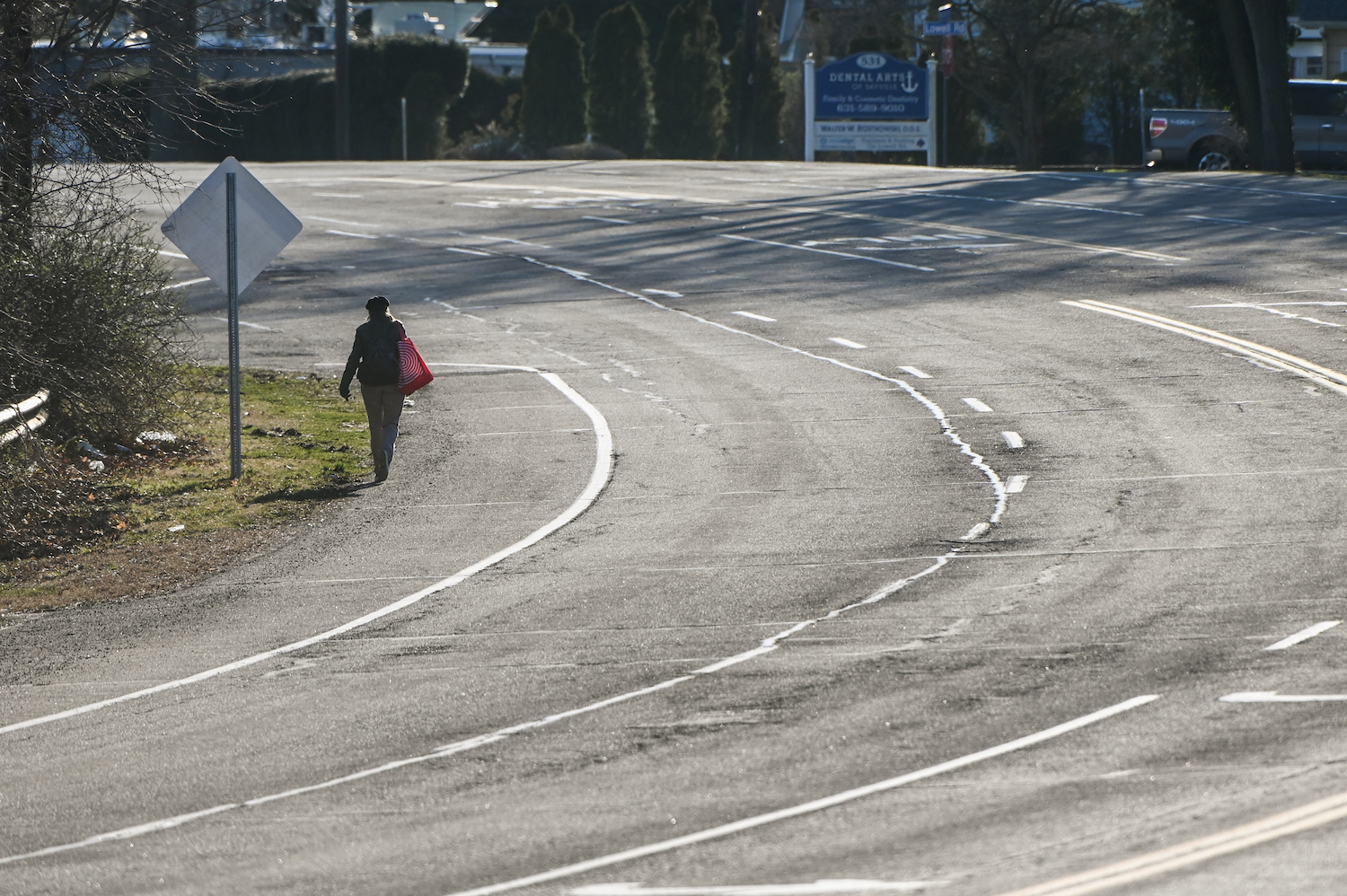 This pedestrian is legally allowed to walk on the shoulder of a road without a sidewalk. | Steve Pfost/Newsday RM via Getty Images