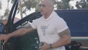 Dwayne Johnson getting out of his Ford F-150. Johnson gave his truck to a veteran at a movie premiere.