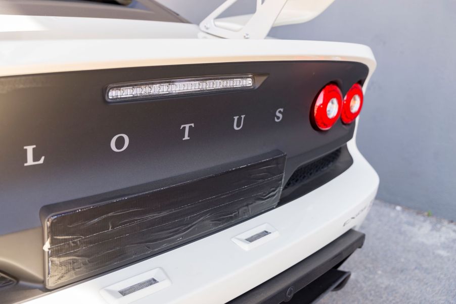 Lotus logo on the back of a white car with a black backend.