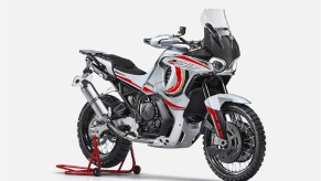 A white-red-and-black MV Agusta Lucky Explorer 9.5 on a rear-wheel stand