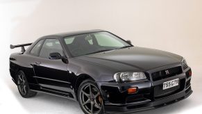 The Nissan R34 GT-R in black shot from the front 3/4