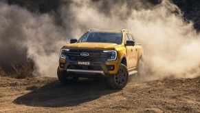 Orange 2023 Ford Ranger driving off-road on a dirt road