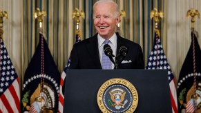 President Joe Biden signing a new infrastructure spending bill. The proposed EV tax credits had to be delayed