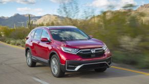 Red 2022 Honda CR-V Touring drivng on a desert road