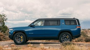 Rivian Blue 2022 Rivian R1S driving off-road in the desert