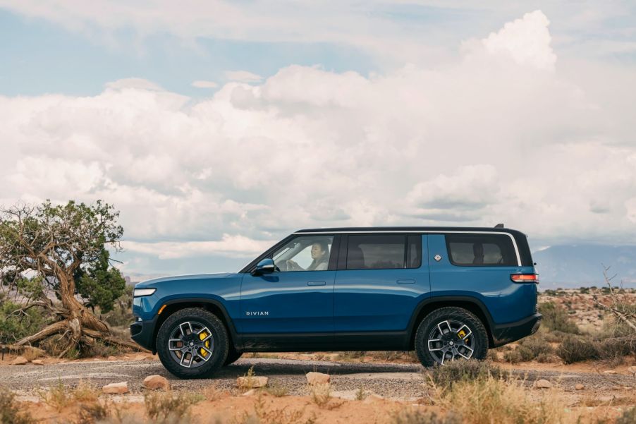 Rivian Blue 2022 Rivian R1S EV SUV driving off-road in the desert