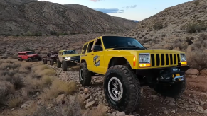 Convoy pulling a dead Jeep out of the river