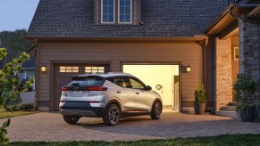 Silver 2022 Chevy Bolt EUV crossover EV parked near a house