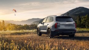 Silver 2022 Kia Telluride, a good SUV for sleep, parked in a field